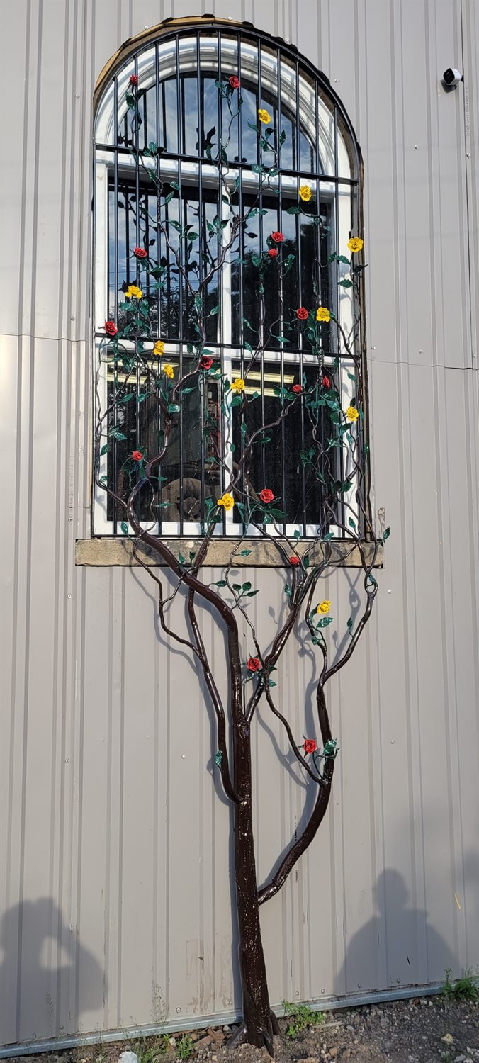Security bars with a bespoke steel tree intertwined through the frame