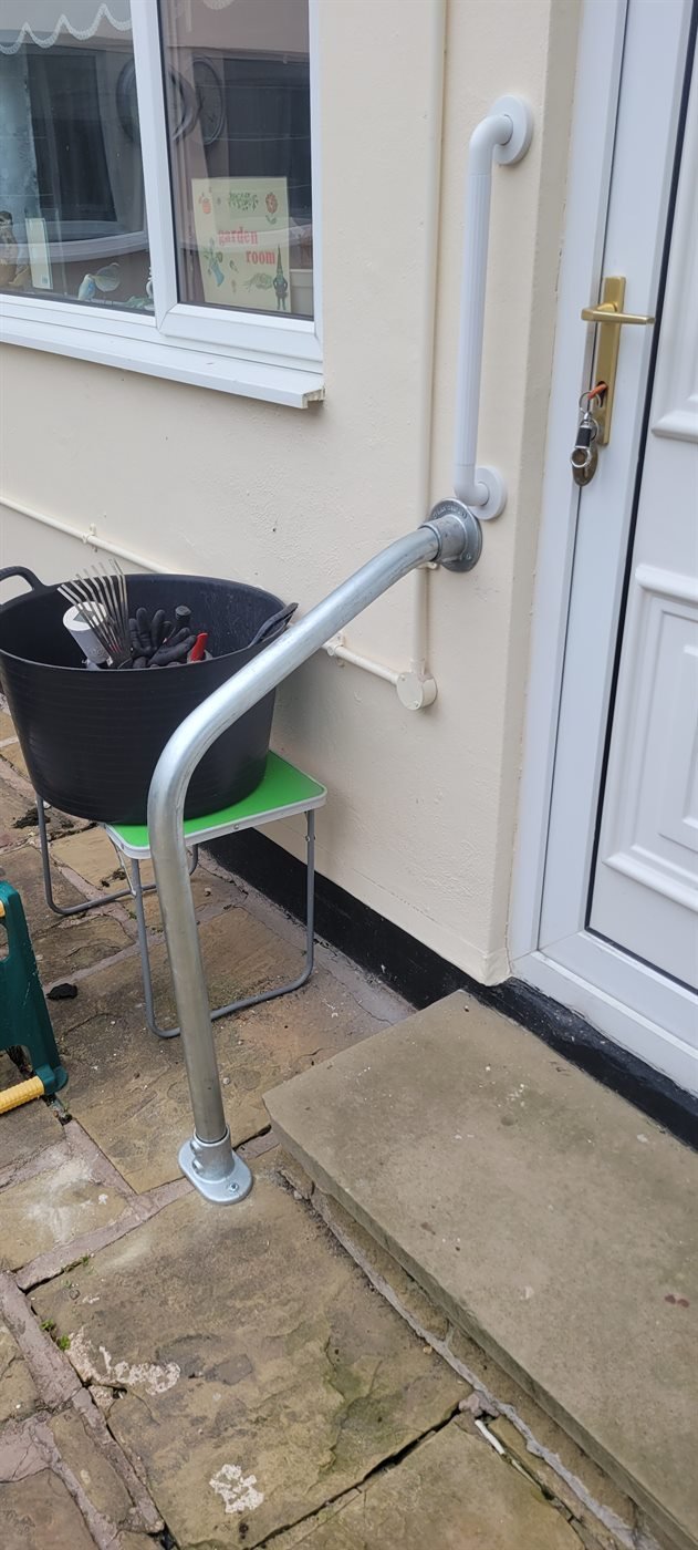 Metal handrail fitted beside outdoor steps