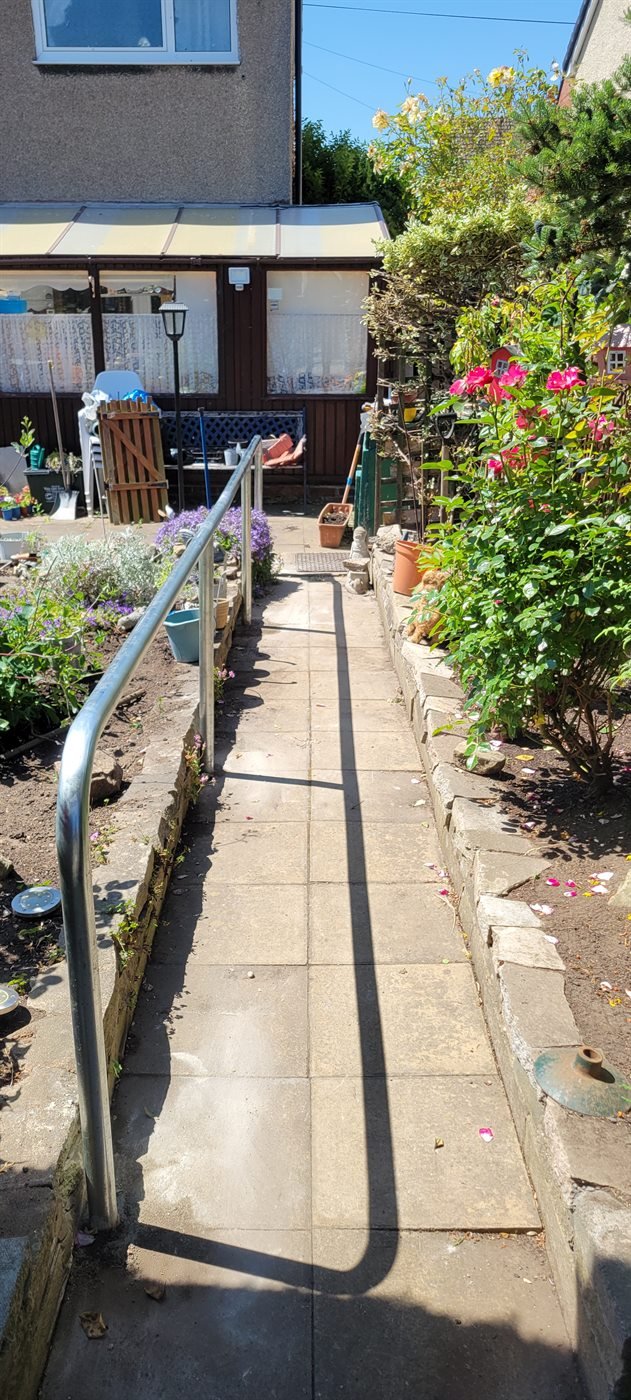 Ramp handrail fitted along a garden access path