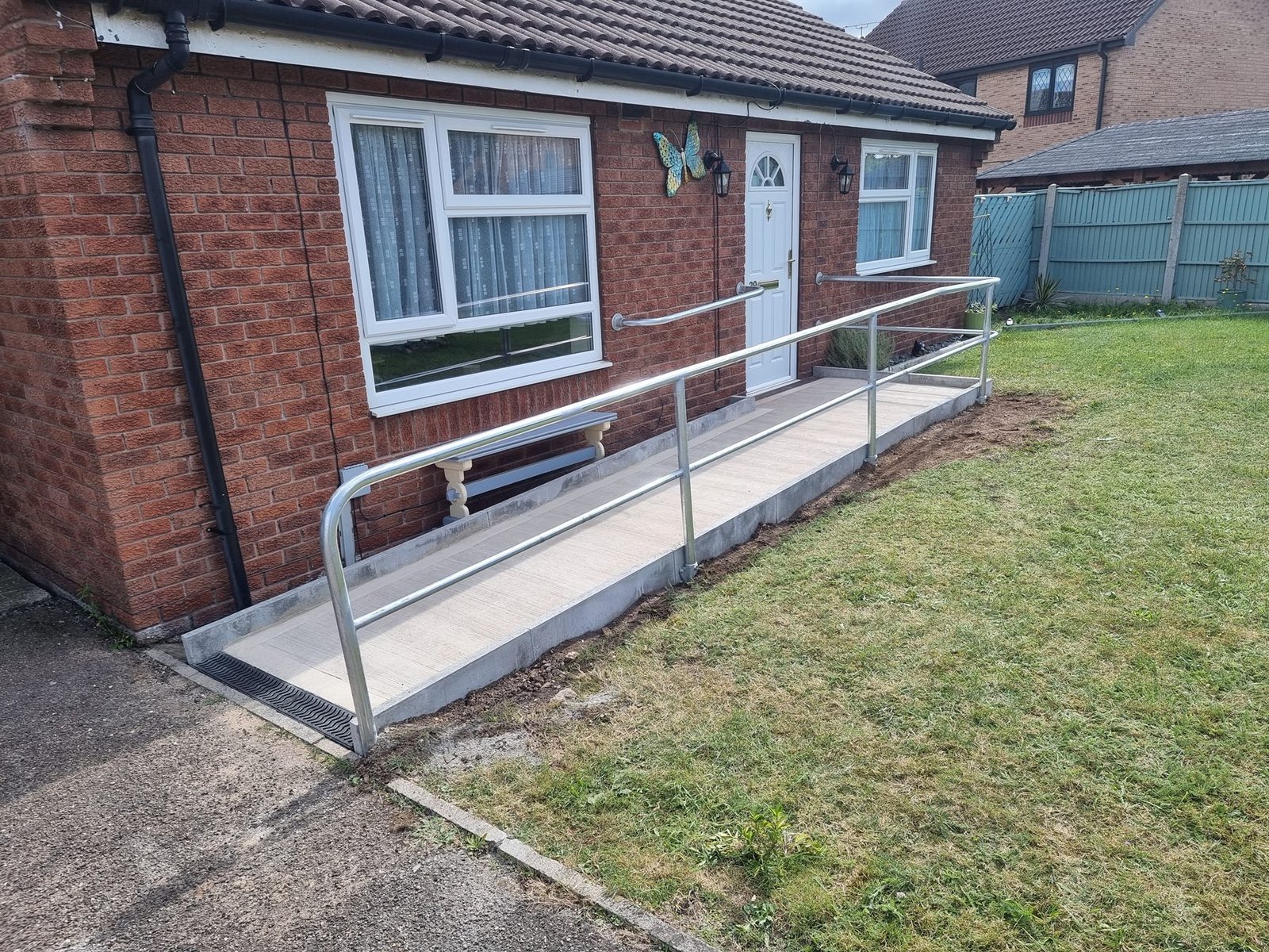 Galvanised steel handrails fitted beside a domestic access ramp